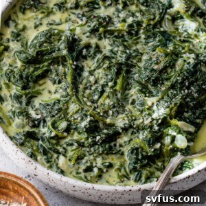 creamed spinach in a bowl with a spoon