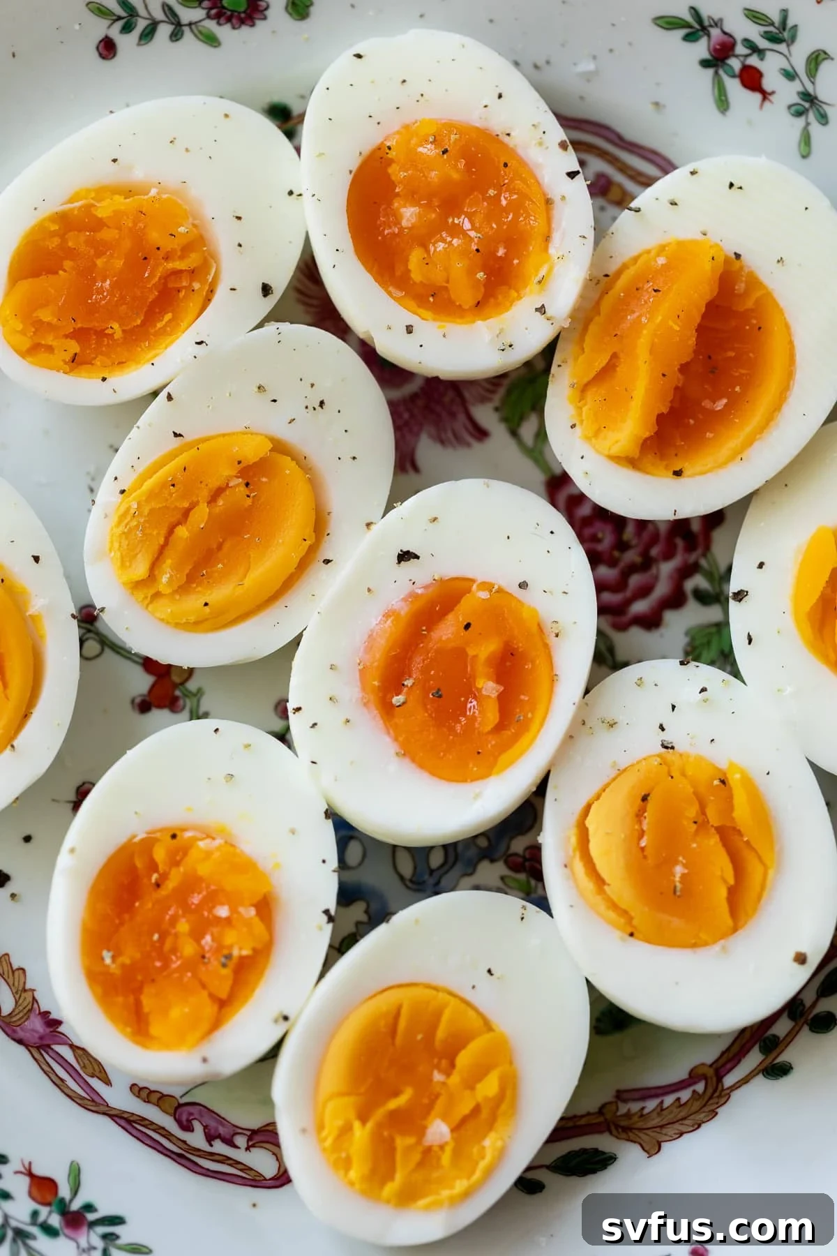 hard boiled eggs on a plate with ground pepper on top