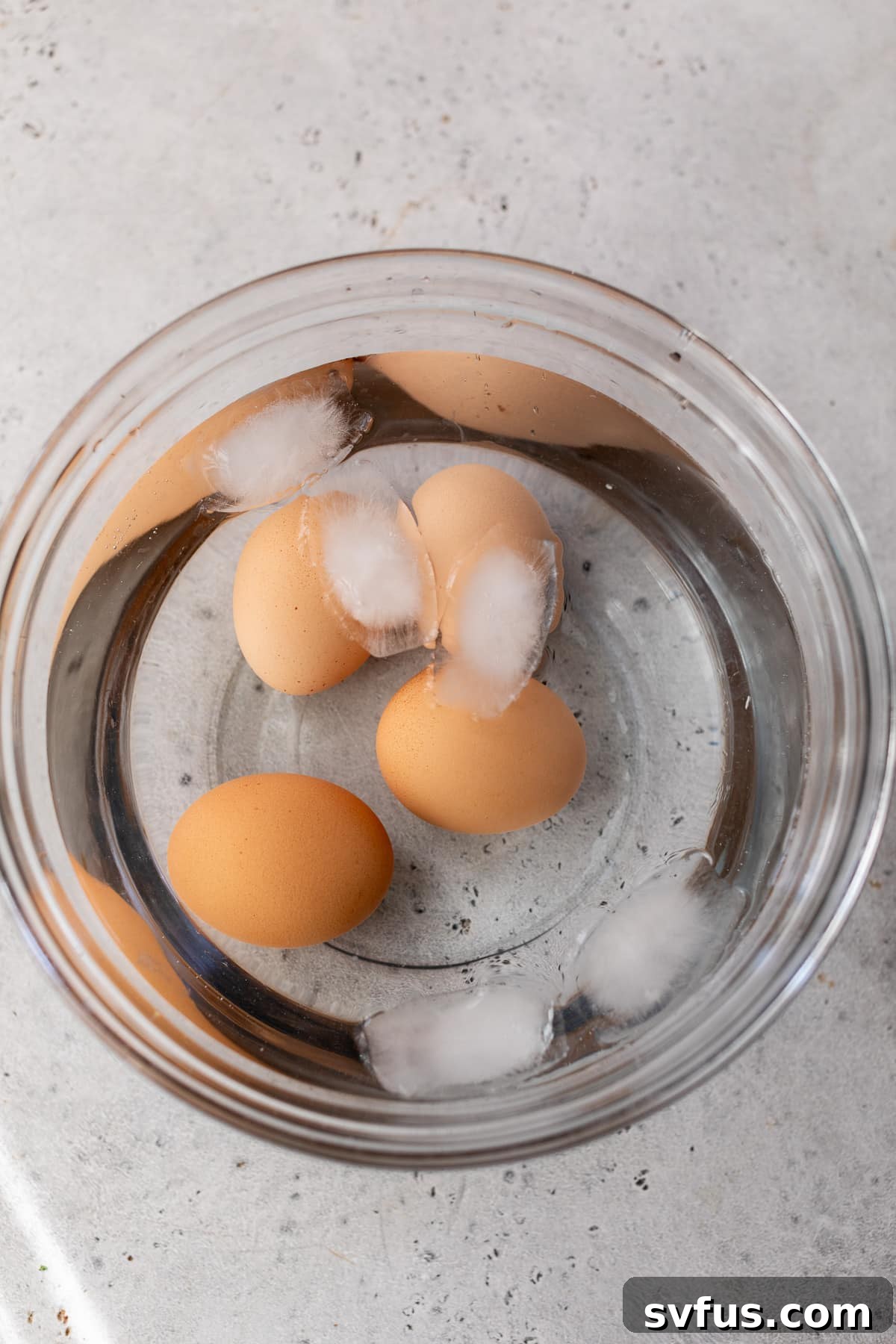 three eggs in a bowl of ice water