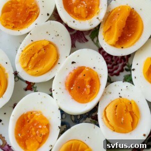 hard boiled eggs on a plate with ground pepper on top