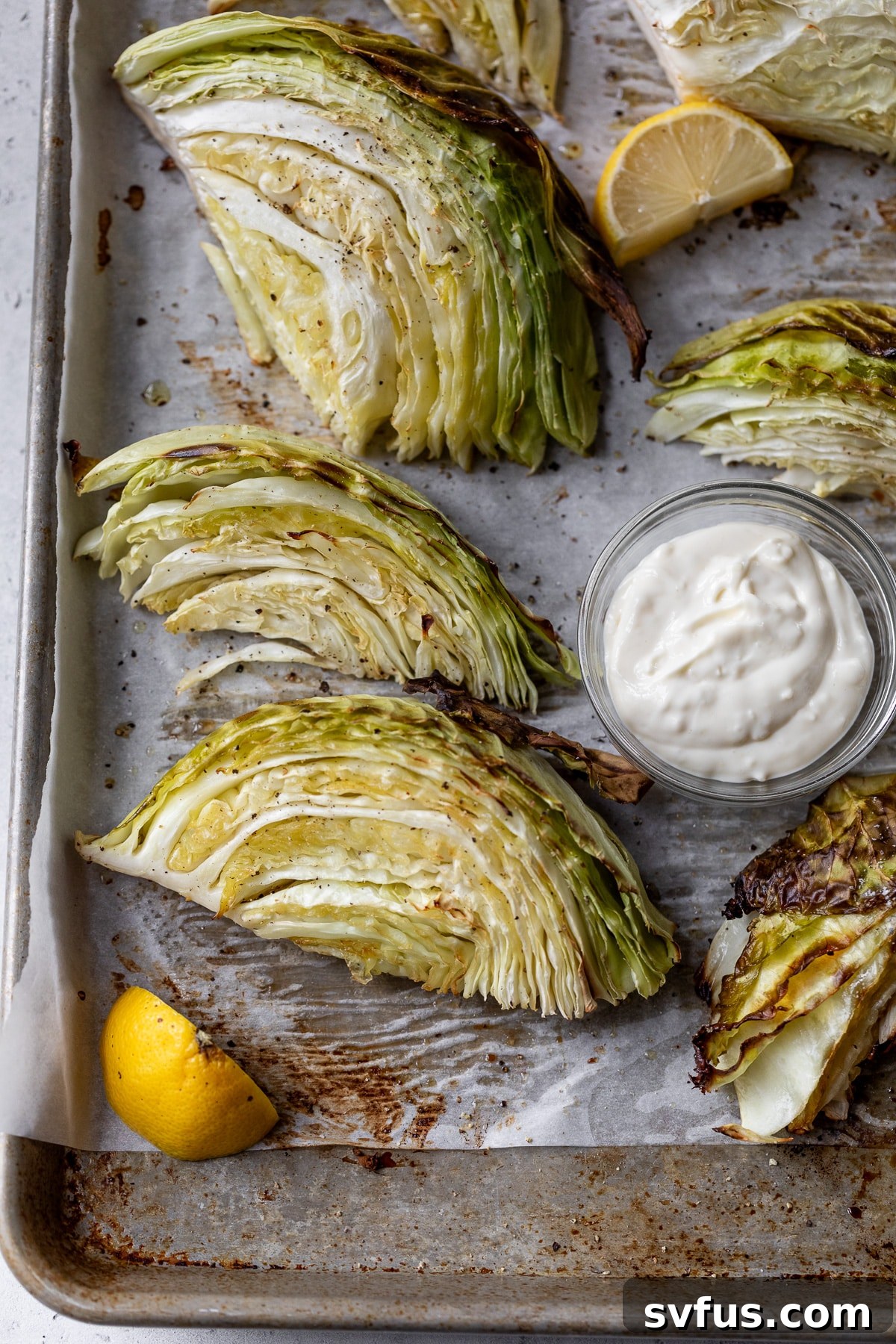 roasted cabbage wedges on a parchment lined baking sheet