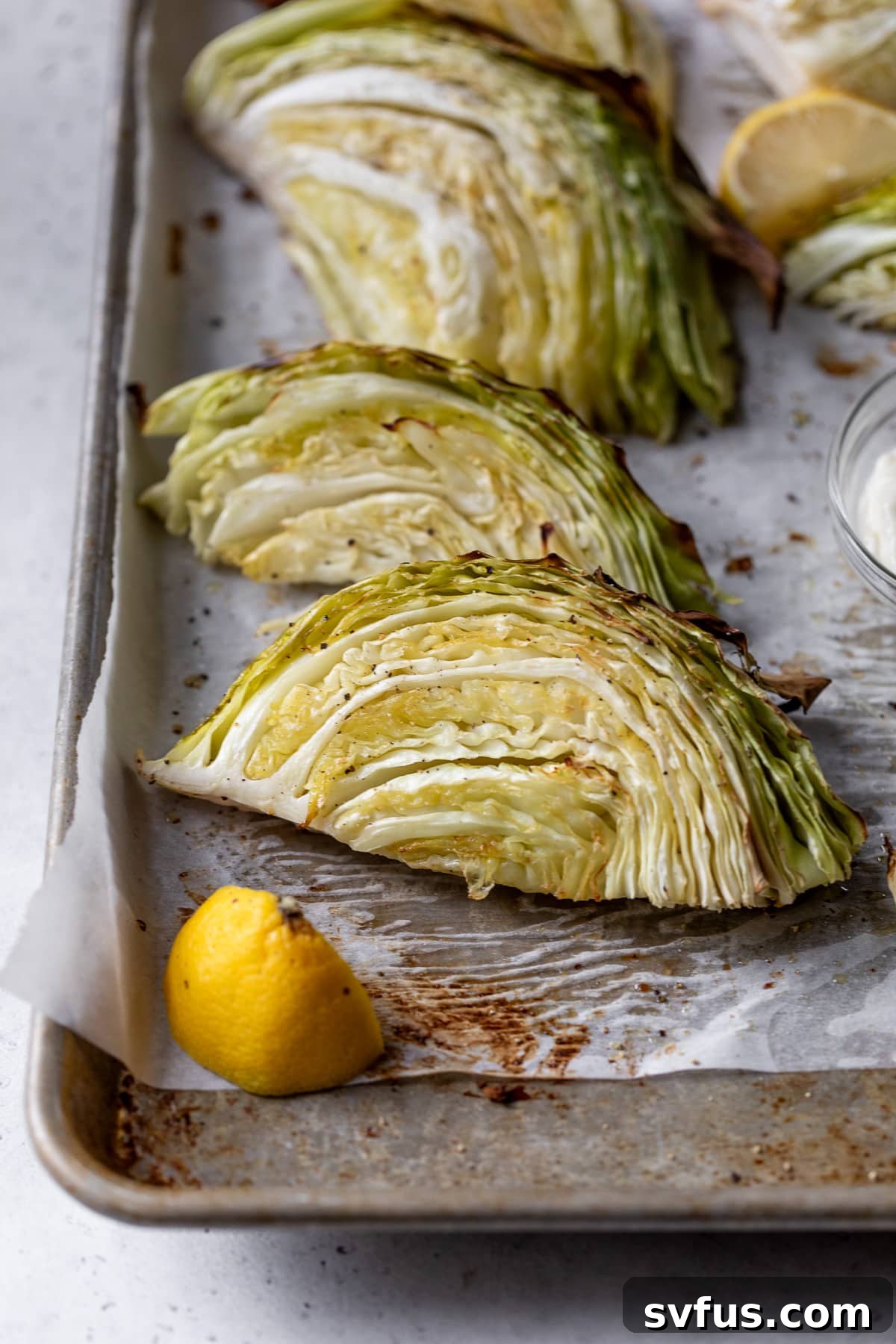 roasted cabbage wedges on a parchment lined baking sheet
