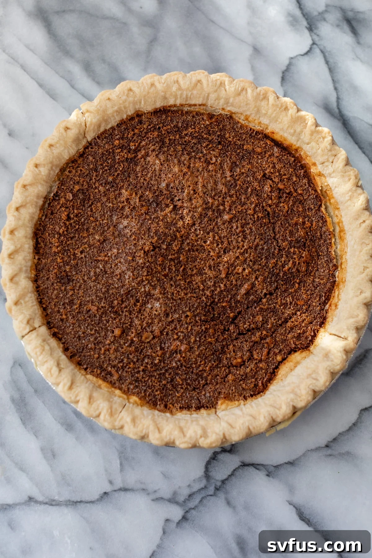 A beautiful overview shot of a whole gingerbread pie, perfectly baked and ready for topping.