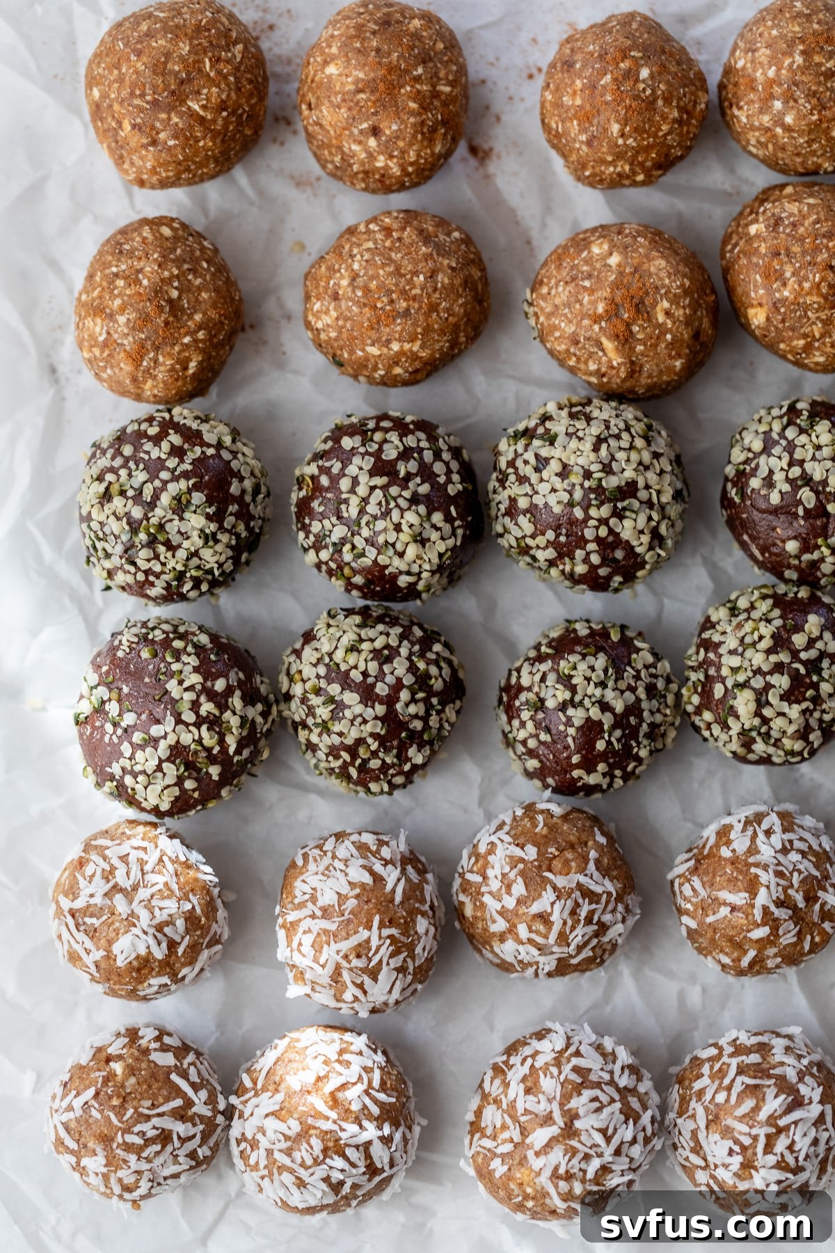 Freshly rolled date energy balls arranged neatly on parchment paper, ready for chilling.