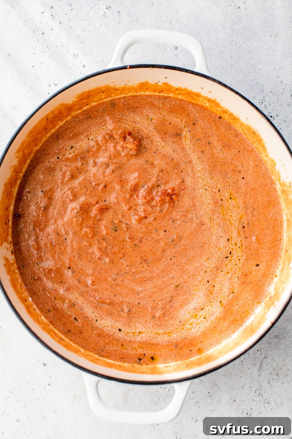 tomato sauce simmering in a dutch oven
