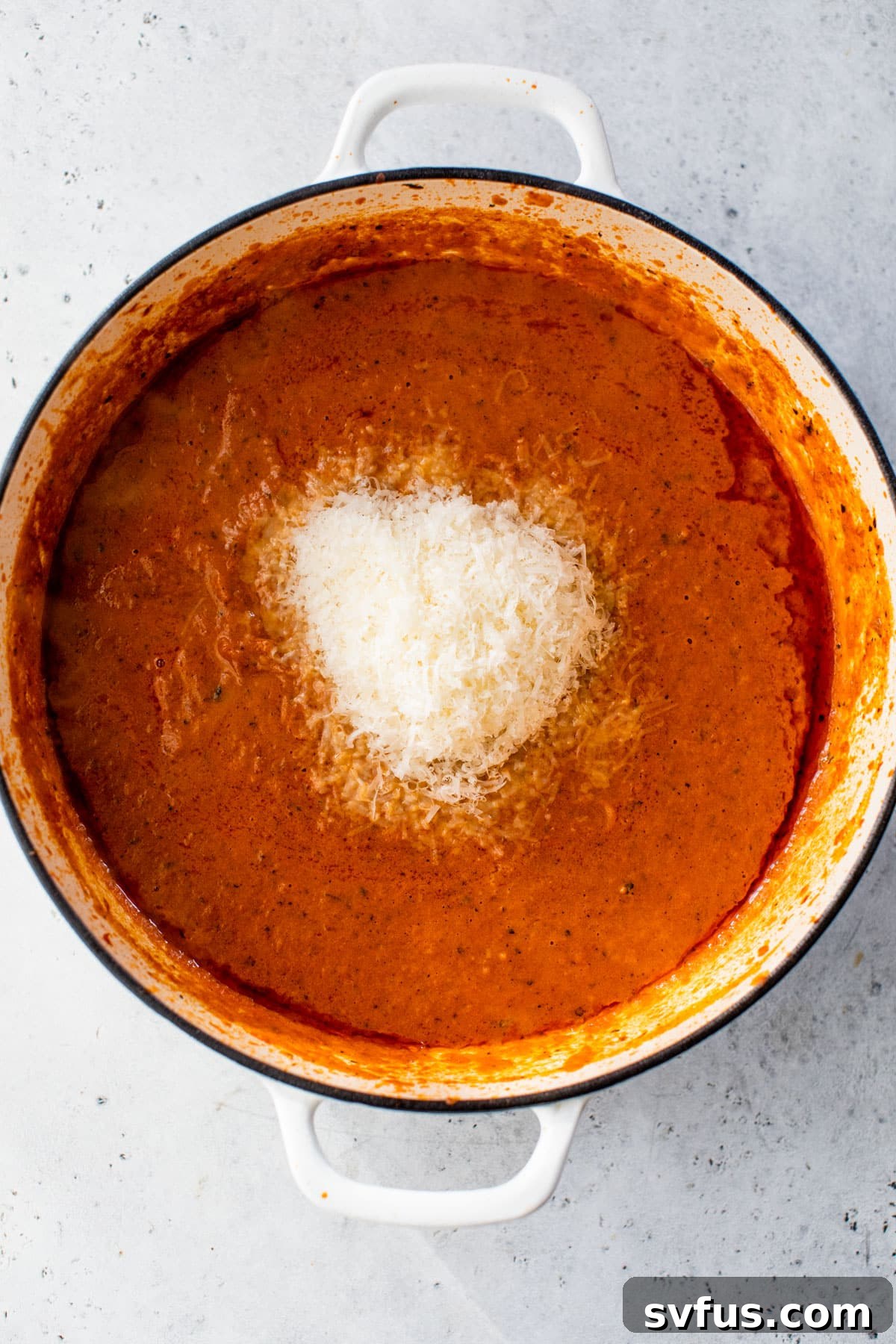 freshly grated parmesan cheese added to the tomato sauce in a dutch oven