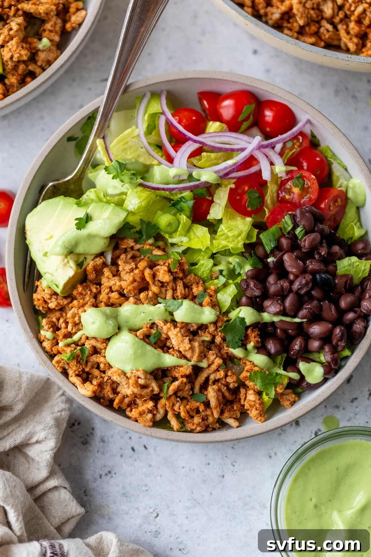 A vibrant Southwest Chicken Bowl with a fork ready to dig in.