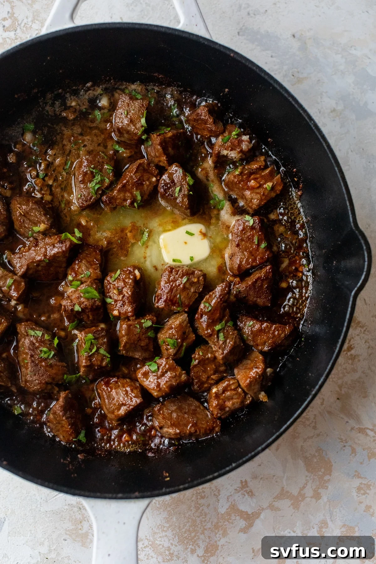 Cajun Steak Bites in a glass container, ready for meal prep or storage in the refrigerator.