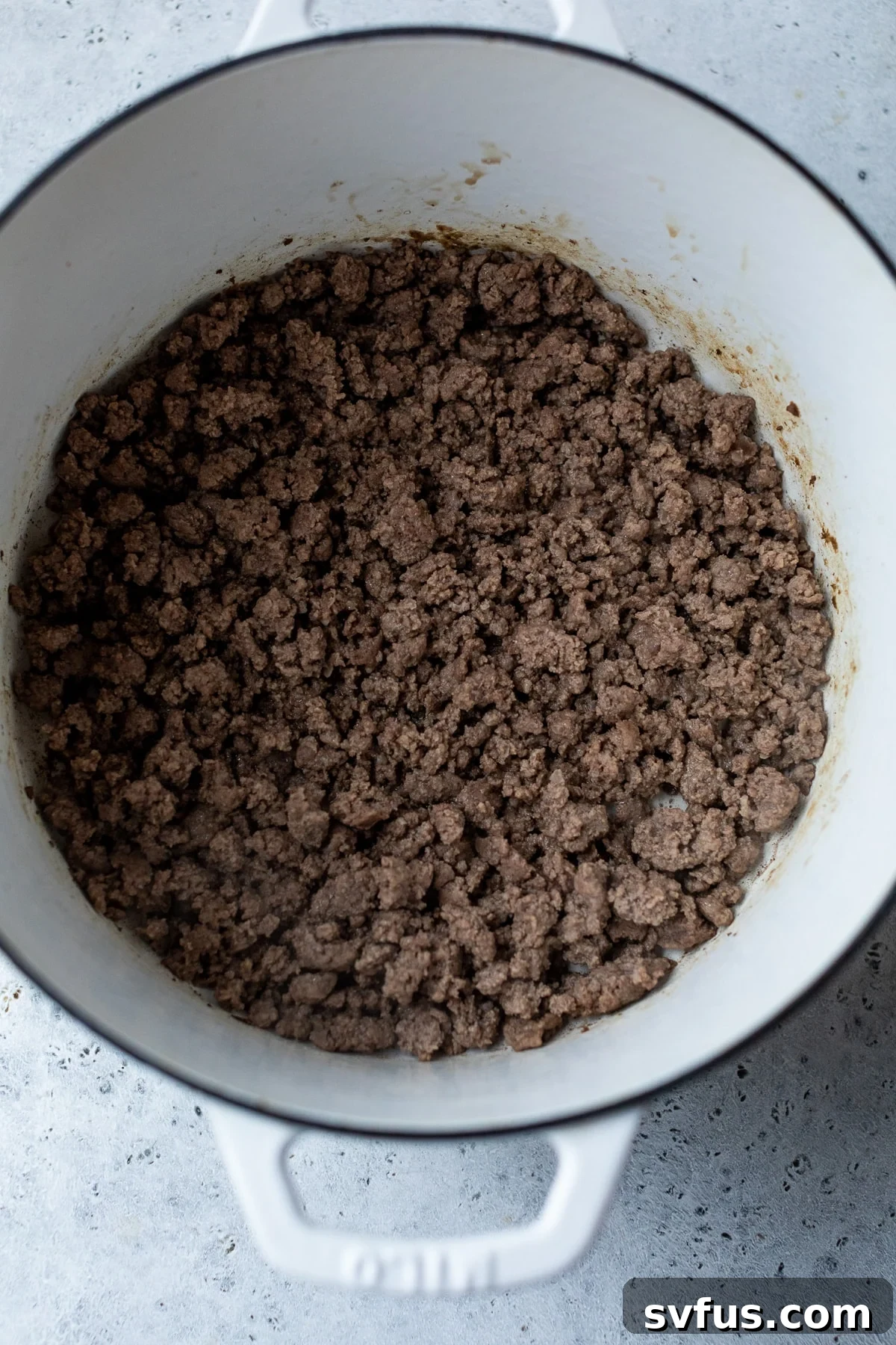 ground beef cooking in a dutch oven