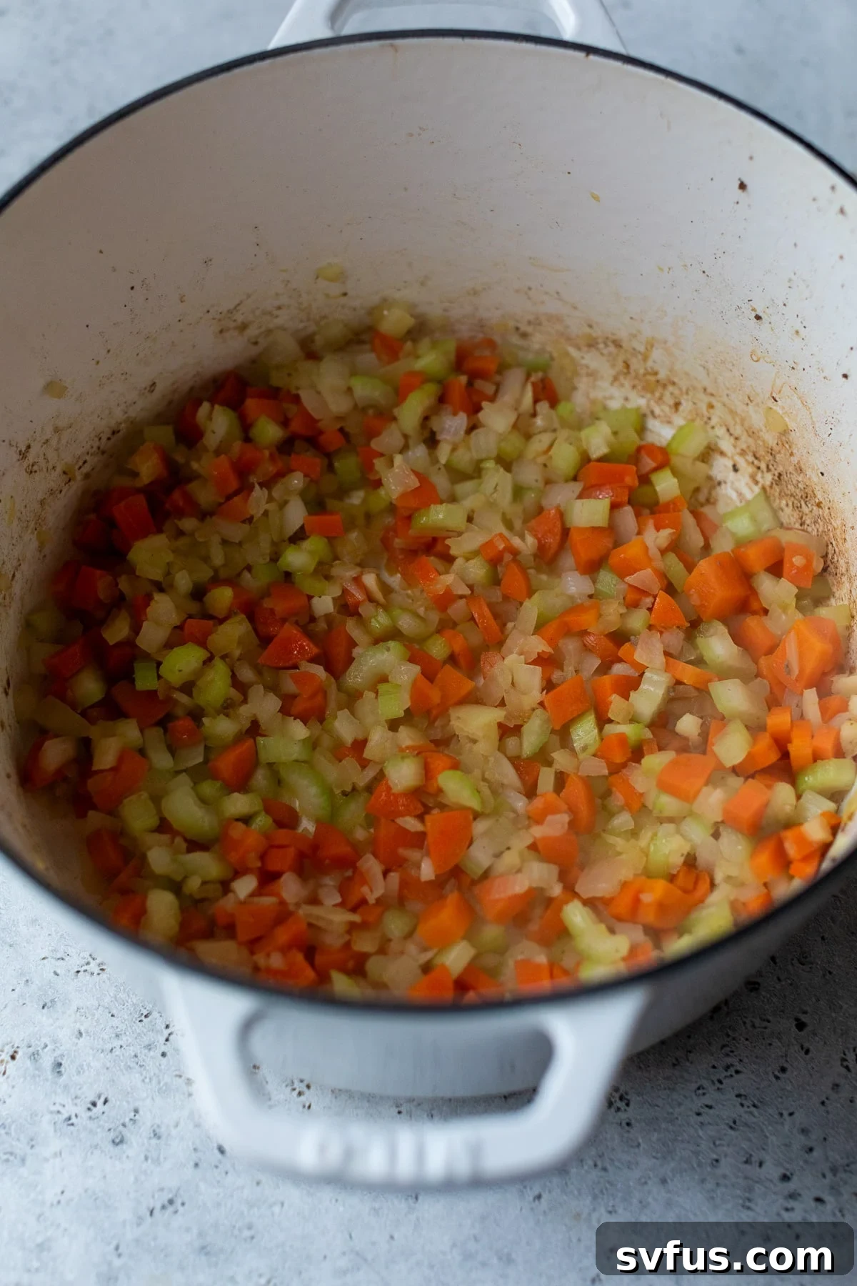 diced vegetables cooking in a dutch oven