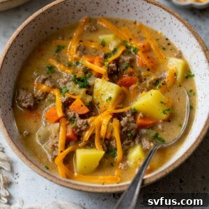 cheeseburger soup in a bowl with a spoon