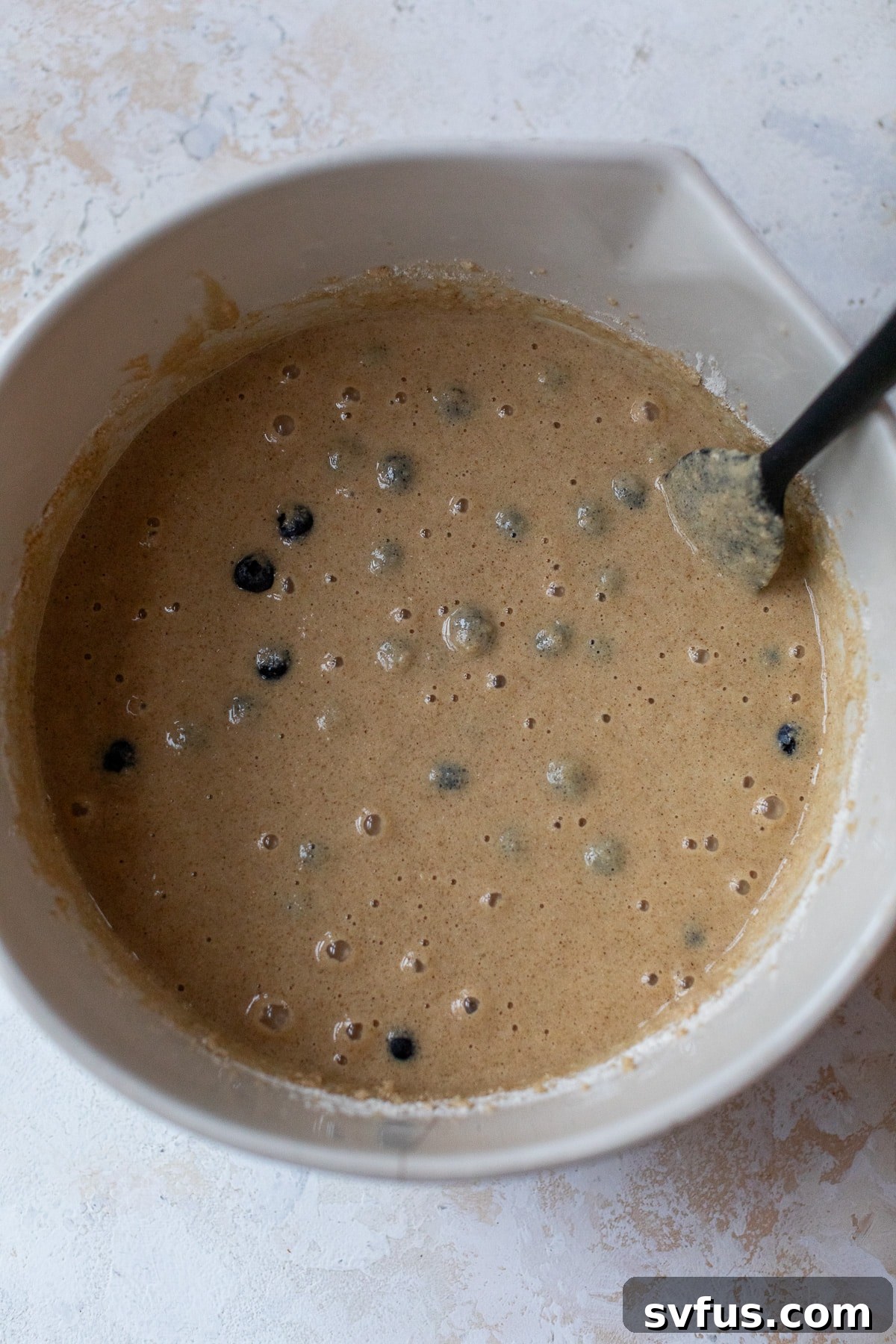 blueberry cake batter ina. large bowl with a spatula