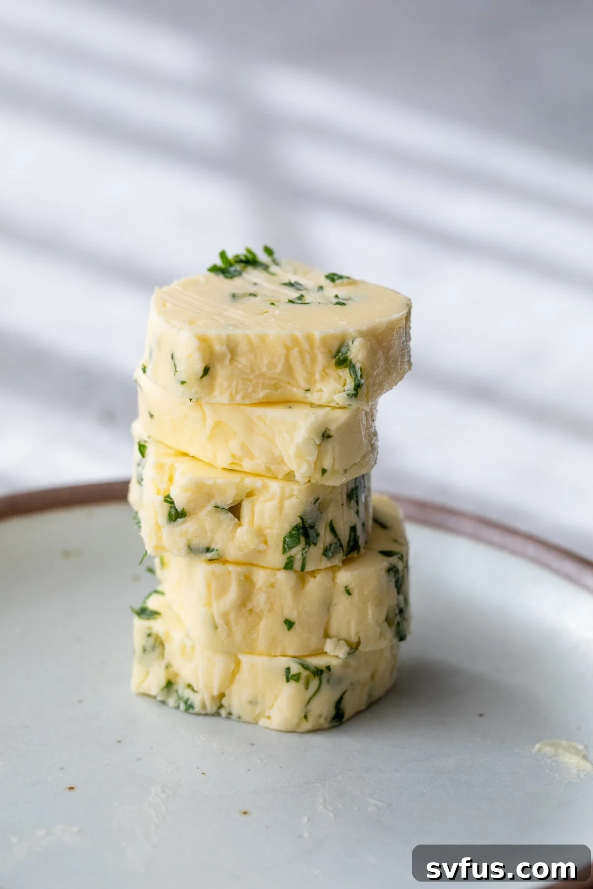 garlic butter rounds stacked on a plate