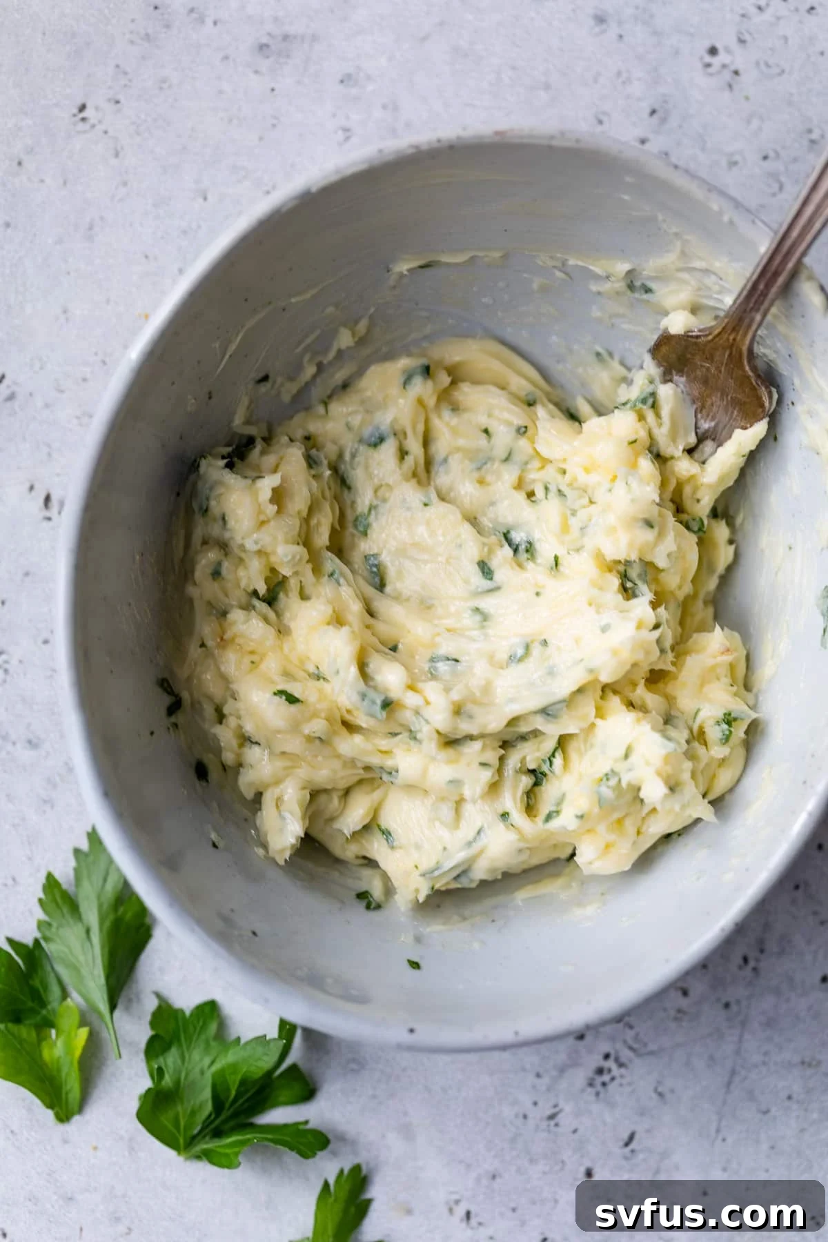 mashed garlic butter in a bowl with a fork