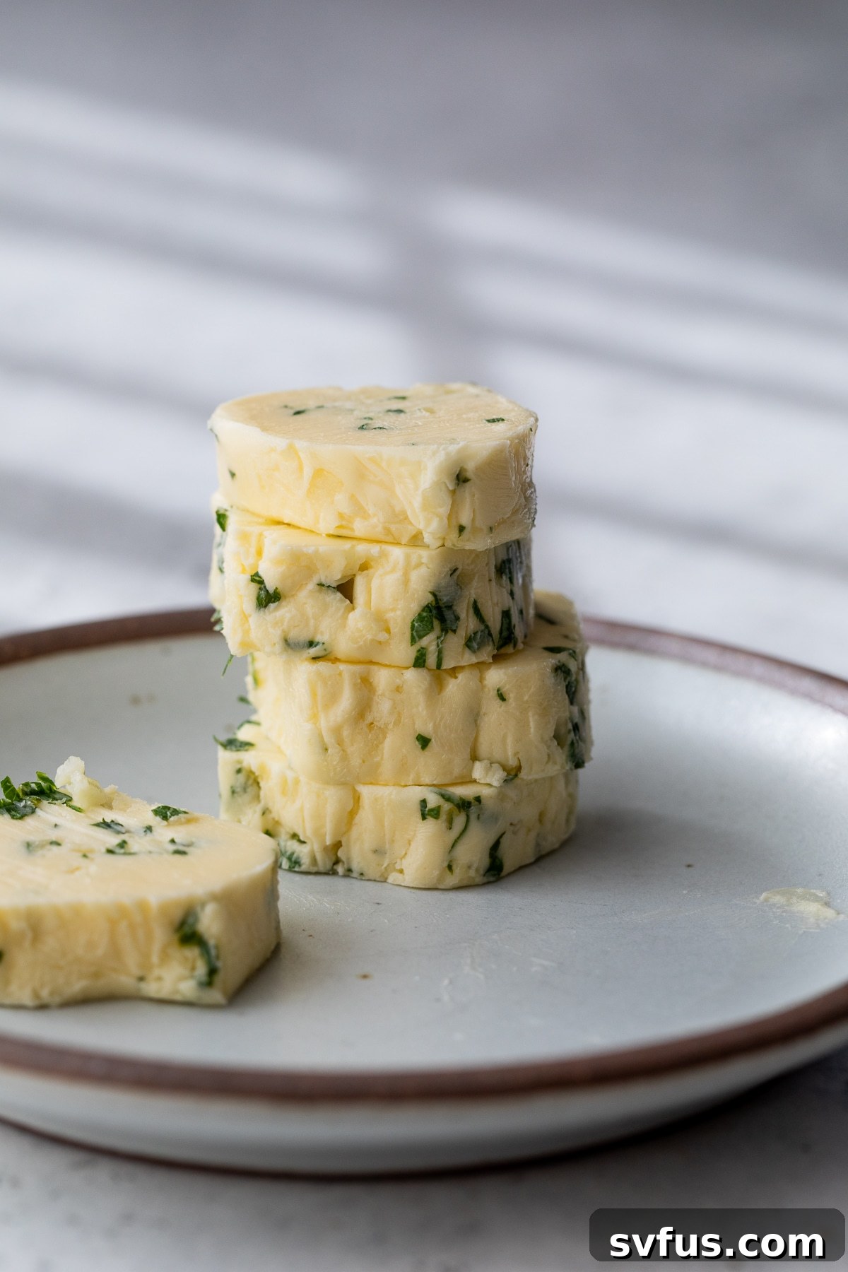 garlic butter rounds stacked on a plate