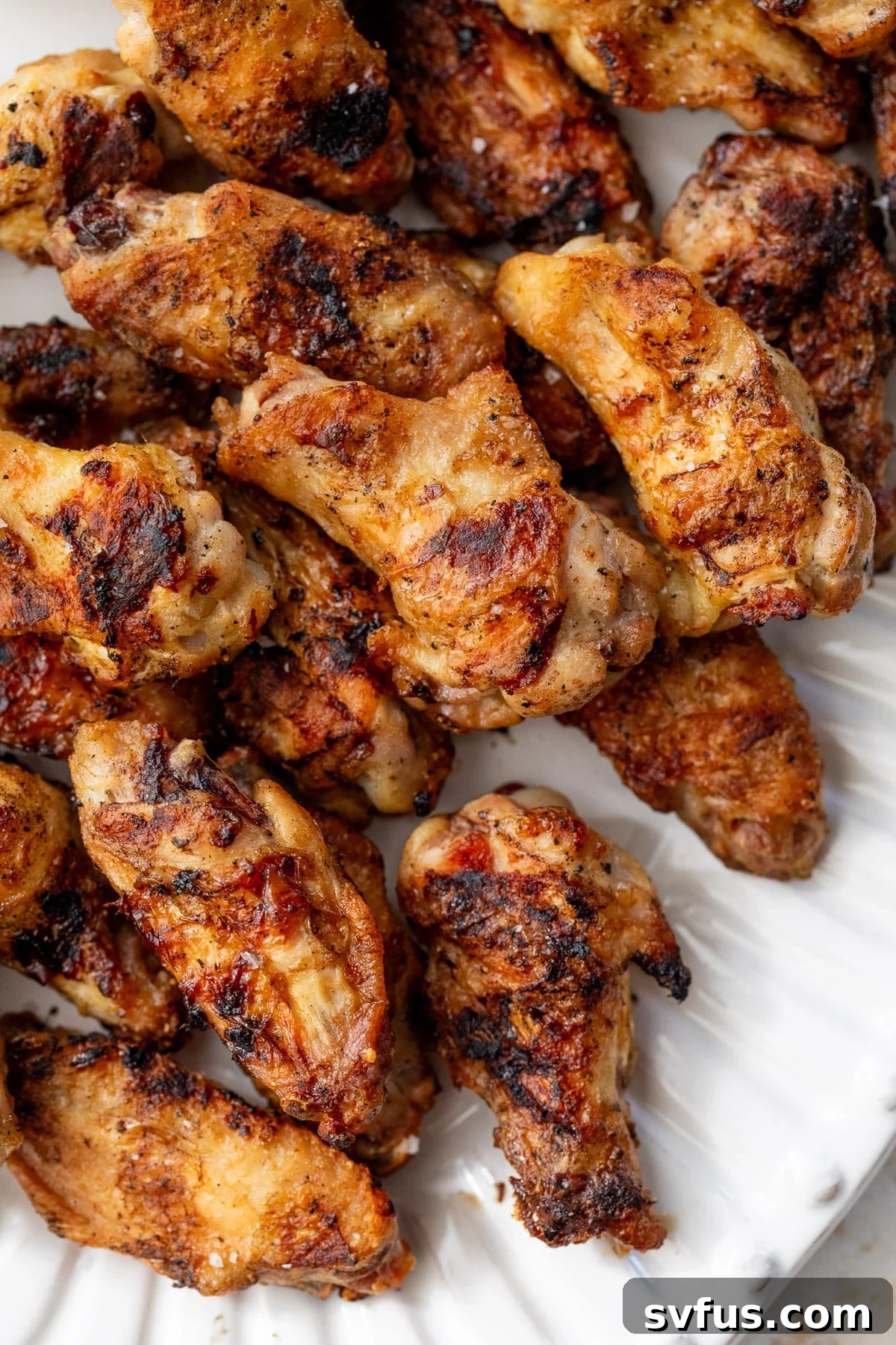 close up on a platter of grilled chicken wings.