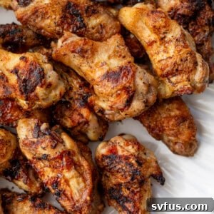close up on a platter of grilled chicken wings.