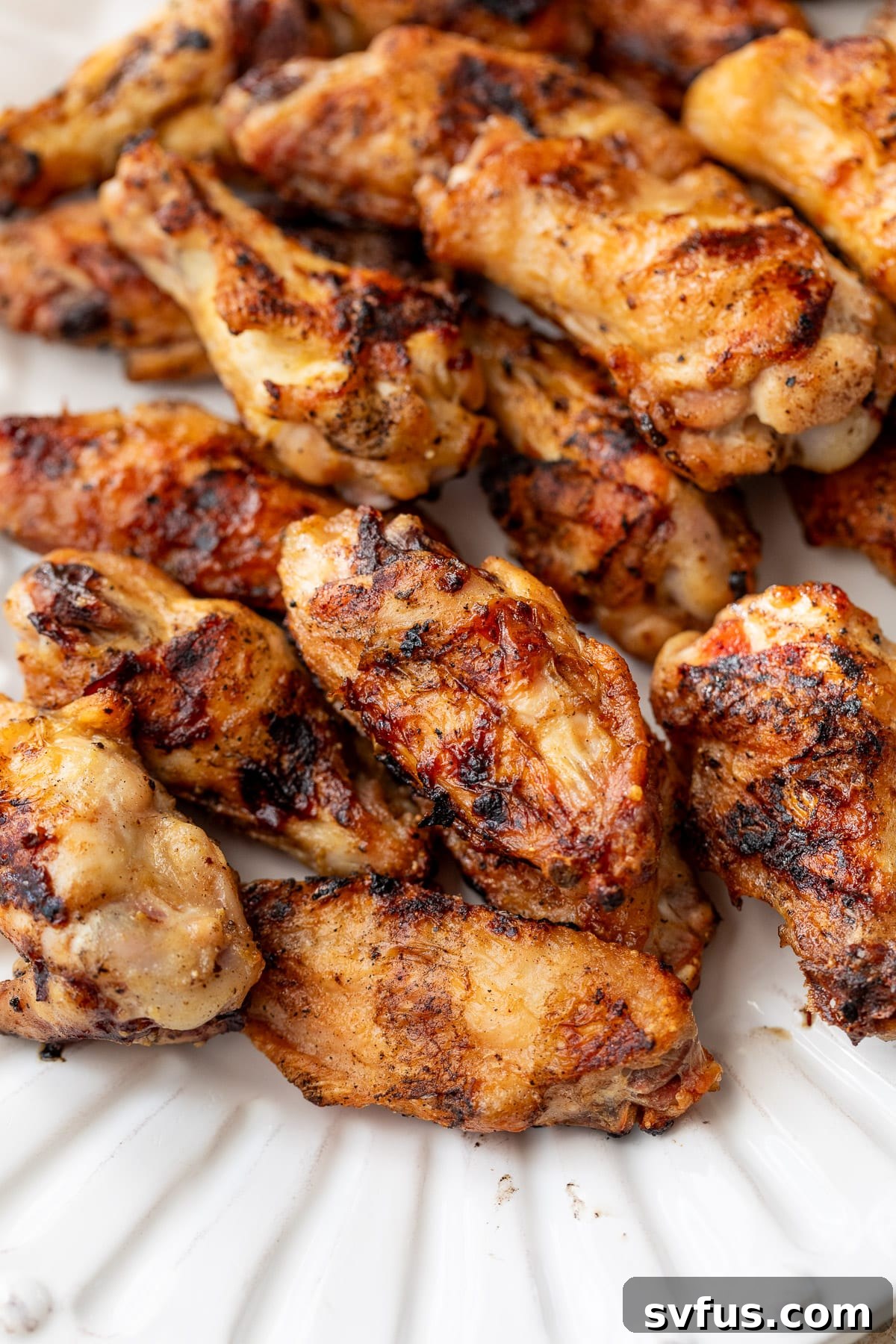 close up on a platter of grilled chicken wings.