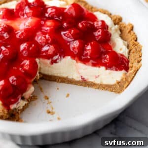 A delicious No Bake Cherry Cheesecake with a slice taken out