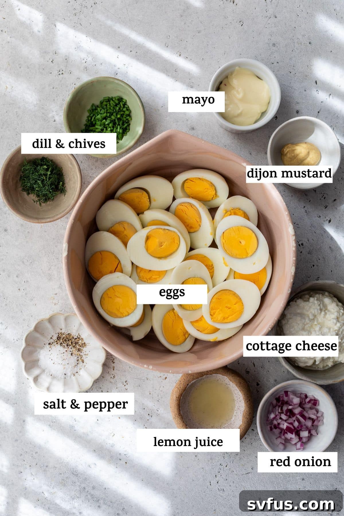 Individual bowls displaying all the fresh and essential ingredients for Cottage Cheese Egg Salad, clearly labeled for easy identification.
