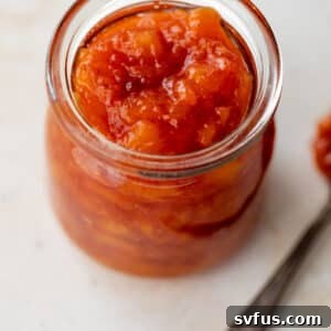 close up on a jar of peach preserves.