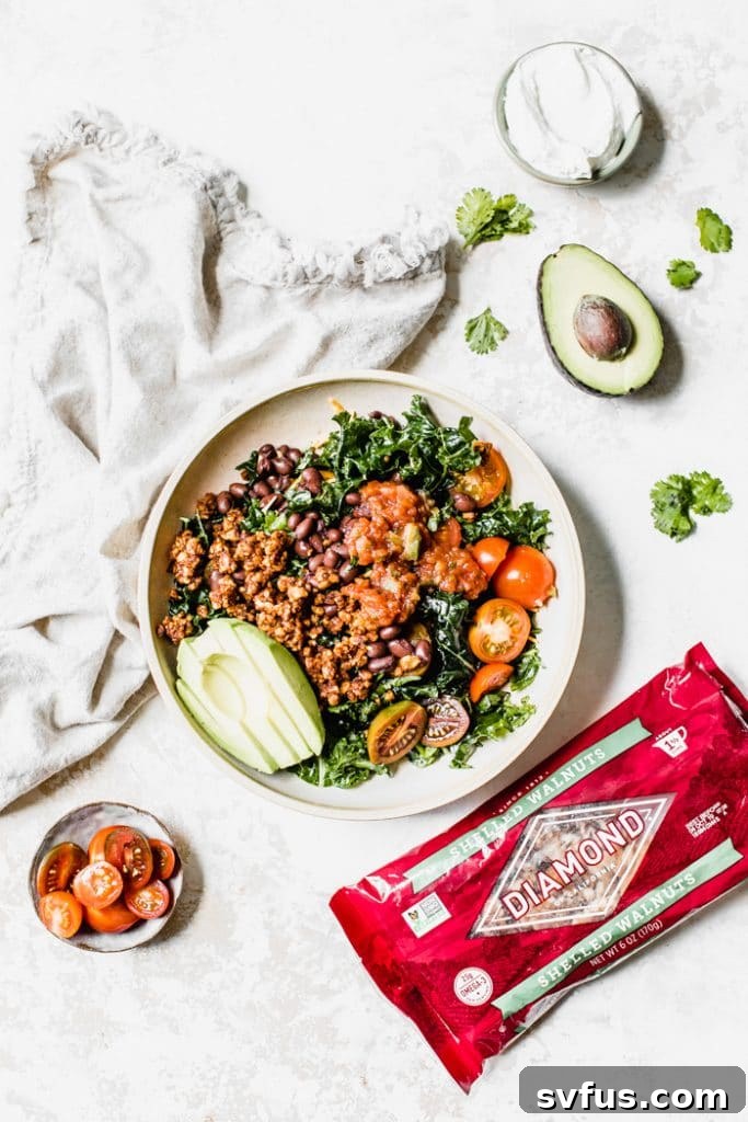 Delicious and healthy kale taco salad made with walnut taco "meat", tomatoes, black beans, and avocado #vegetarian #lowcarb