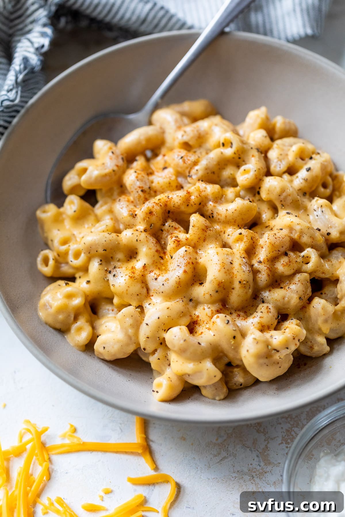 overhead view of a beautifully presented bowl filled with cottage cheese mac and cheese, ready to be enjoyed.