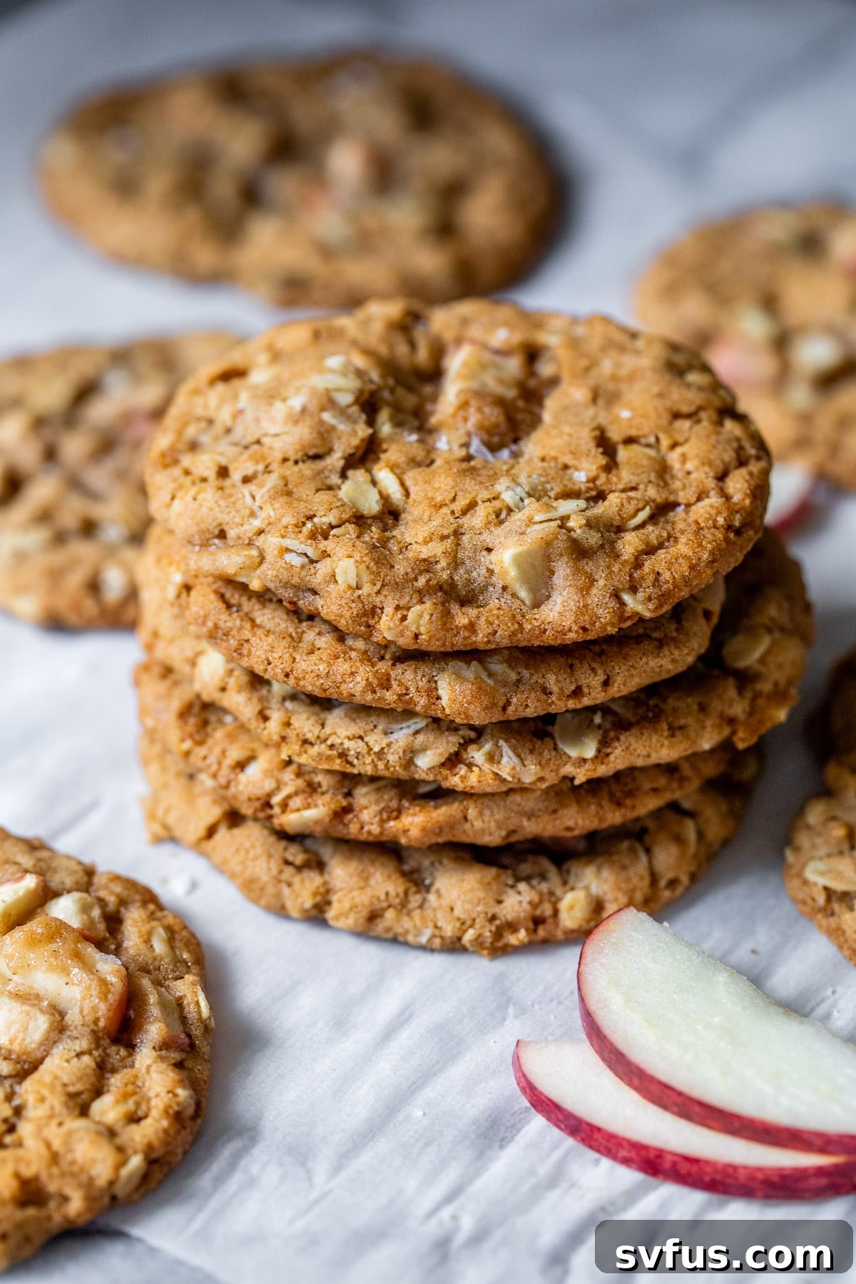 Close up on a stack of freshly baked Apple Oatmeal Cookies, showing off their texture and apple chunks.