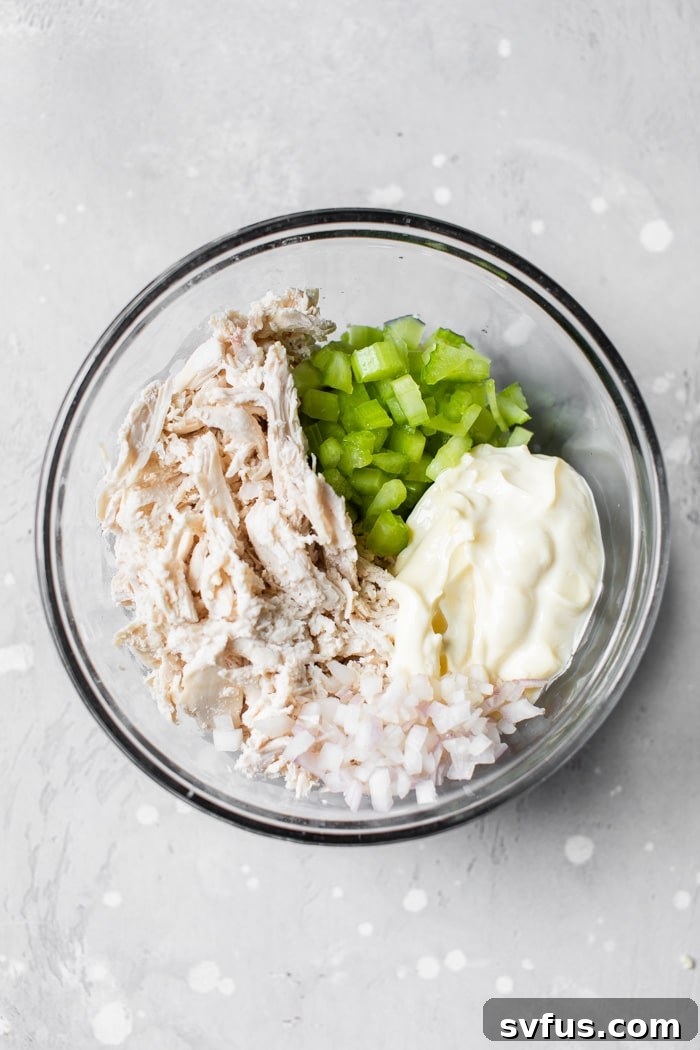 shredded chicken, celery and mayo in a bowl