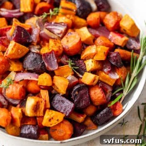 a medley of roasted root vegetables in a large white bowl.
