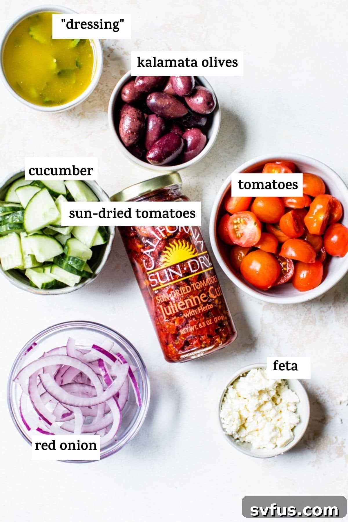 A selection of fresh ingredients including sun-dried tomatoes and red onion, ready for Mediterranean Pasta Salad