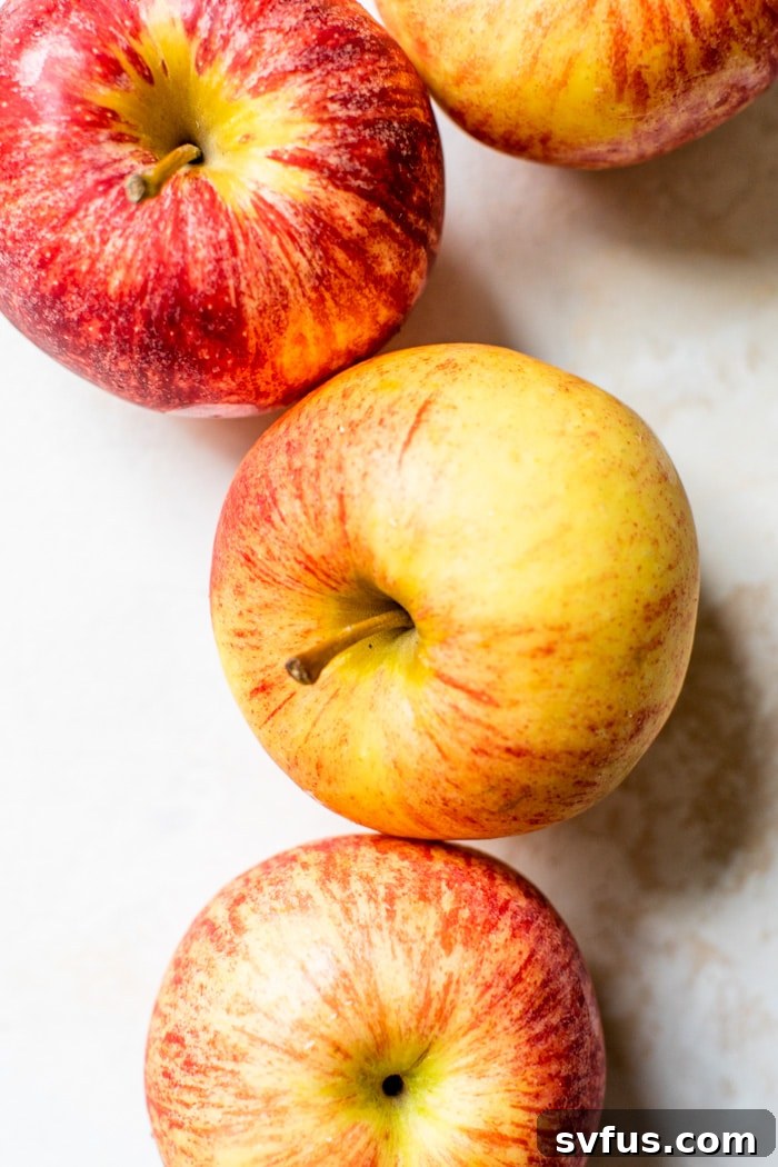 A close-up shot of fresh, red apples, washed and ready for blending, highlighting their crisp texture and vibrant color.