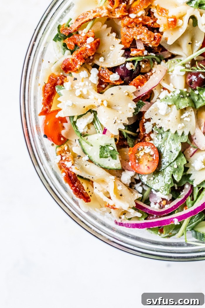 A light and refreshing Mediterranean Pasta Salad loaded with colorful vegetables like cucumbers, sun-dried tomatoes, and fresh herbs, tossed in a zesty dressing.