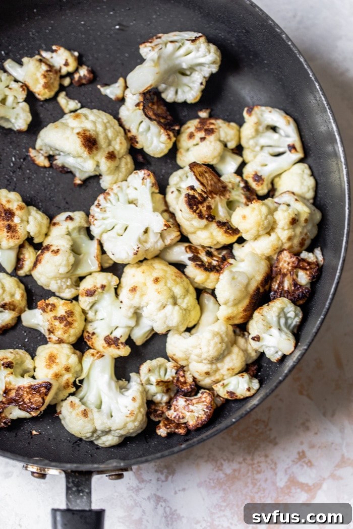 Cauliflower florets searing in a pan for Kung Pao Cauliflower