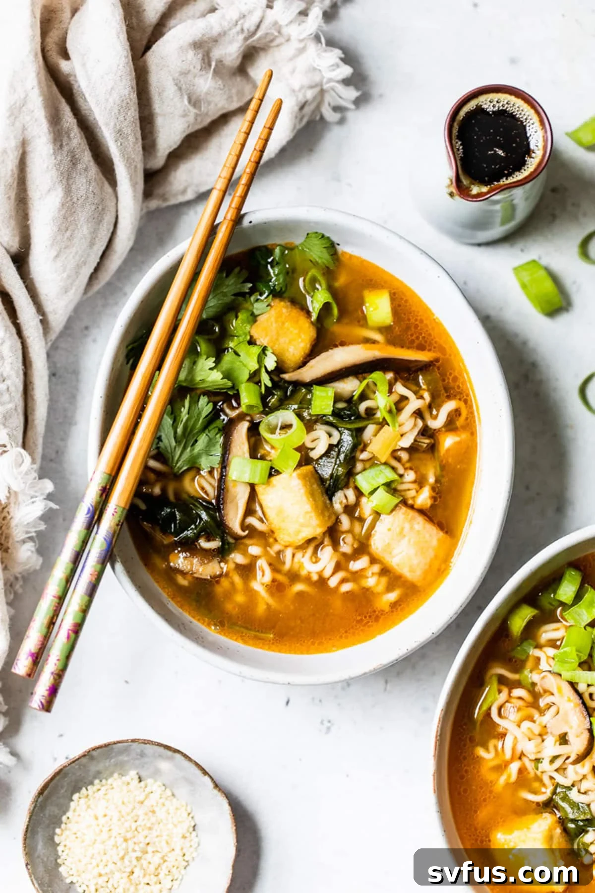 overhead view of a bowl of vegan ramen with chopsticks on top.