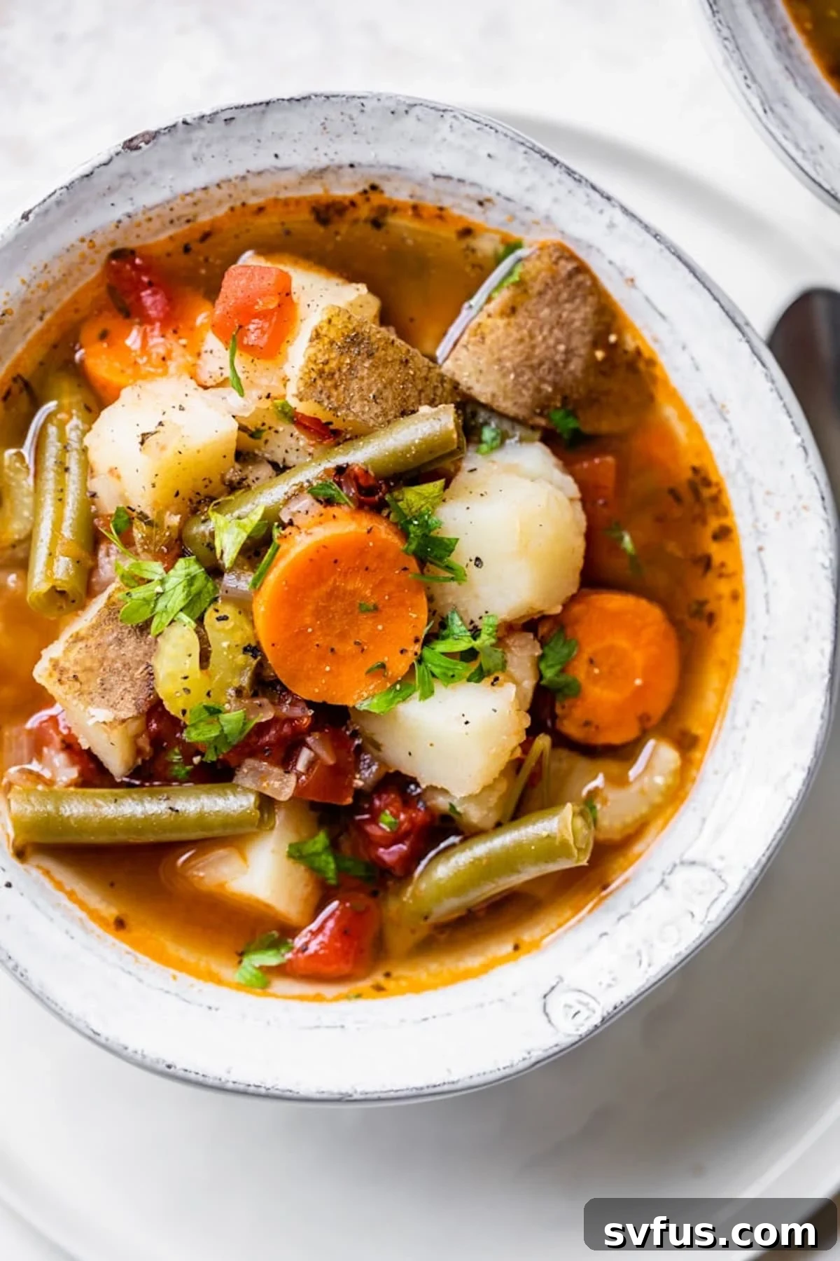 A large, steaming bowl of freshly made Instant Pot Vegetable Soup, garnished with vibrant fresh herbs, ready to be enjoyed.