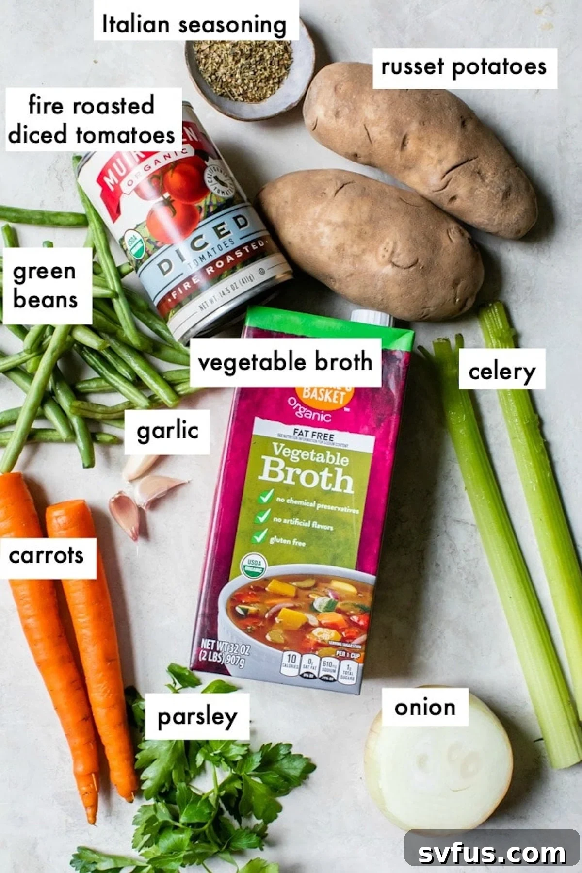 A meticulously arranged display of fresh ingredients for Instant Pot Vegetable Soup, including diced onions, minced garlic, chopped carrots, celery, potatoes, vibrant green beans, fresh parsley, canned fire-roasted tomatoes, and a selection of aromatic spices, all laid out on a rustic wooden surface.