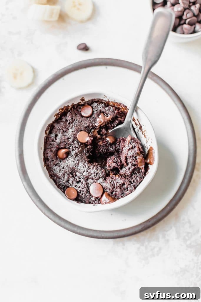 Close-up of a freshly made Chocolate Banana Mug Cake with melted chocolate chips on top