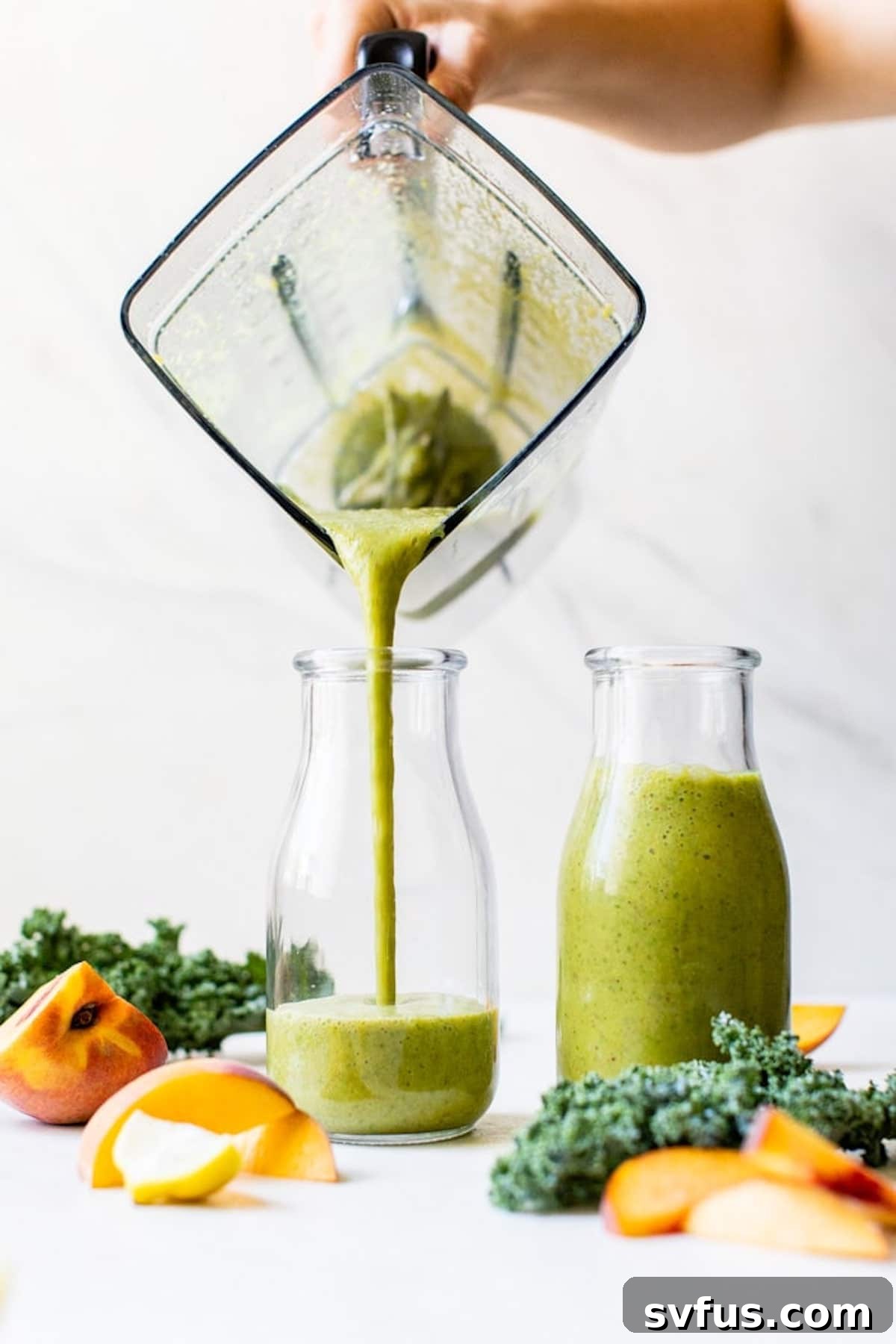 Smoothie being poured from blender into a glass
