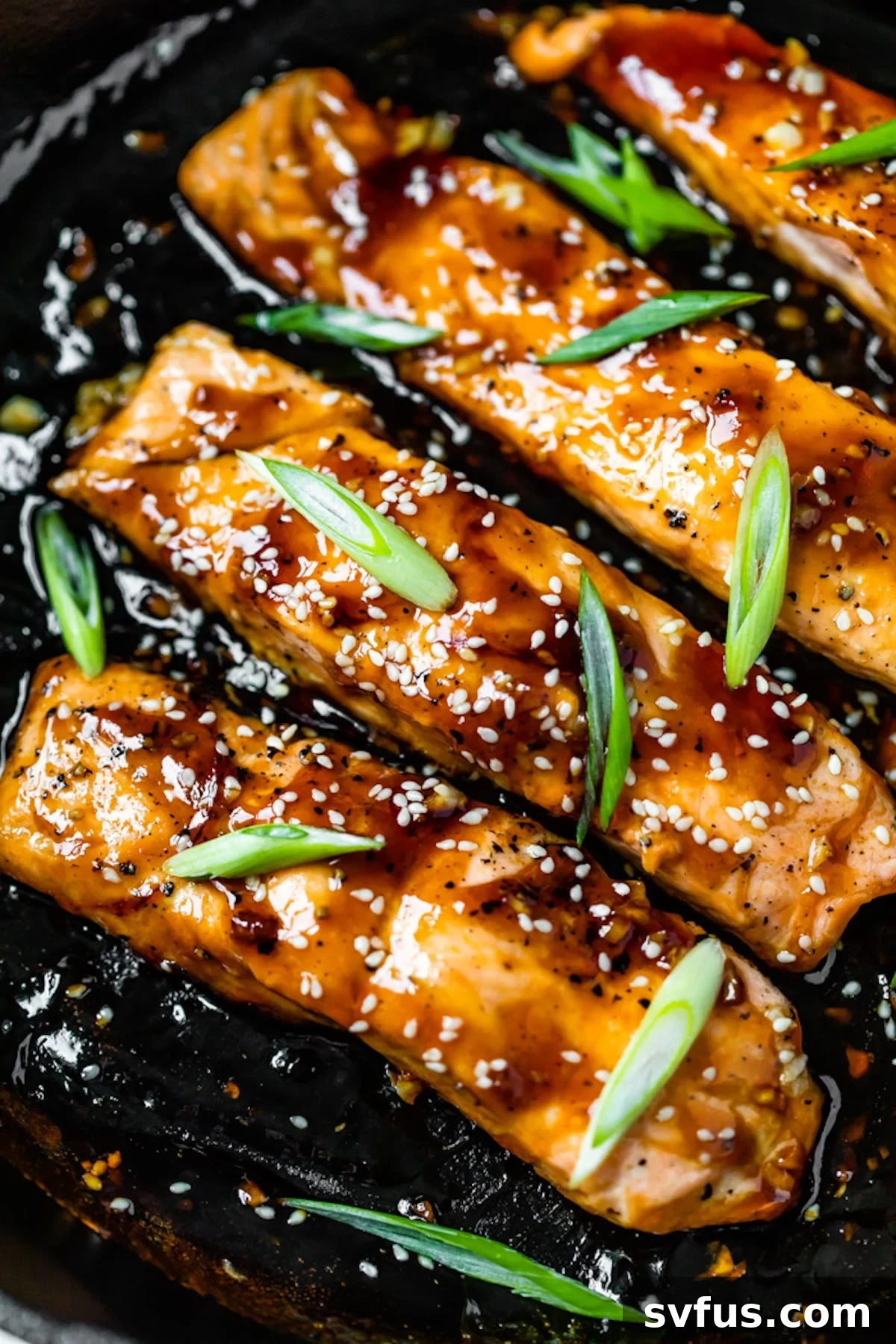 close up photo of glazed salmon in a skillet