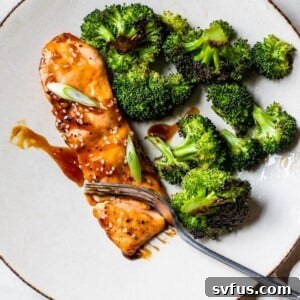 marinated salmon on a plate next to some broccoli