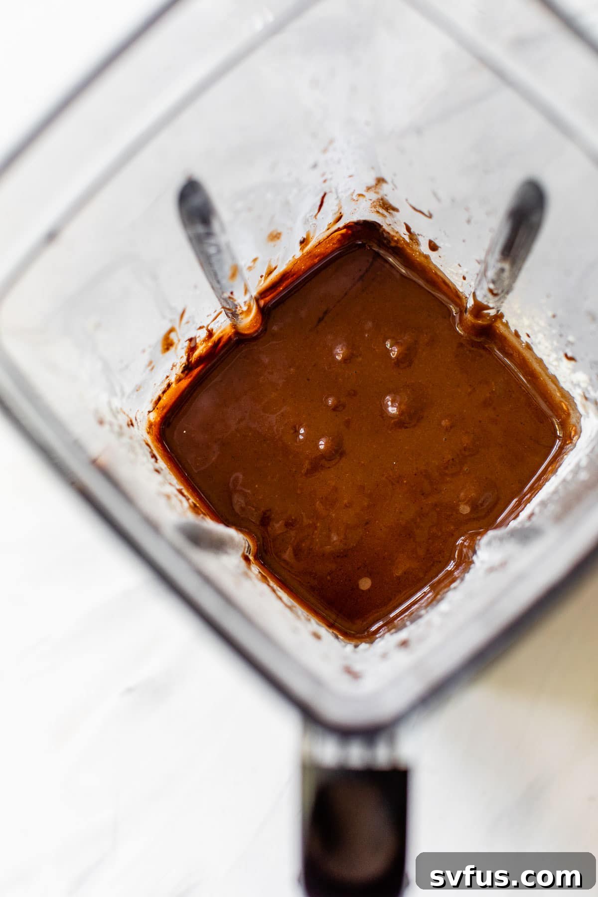 Smooth, blended chocolate pie filling swirled inside a blender jar, ready to be poured into the crust.