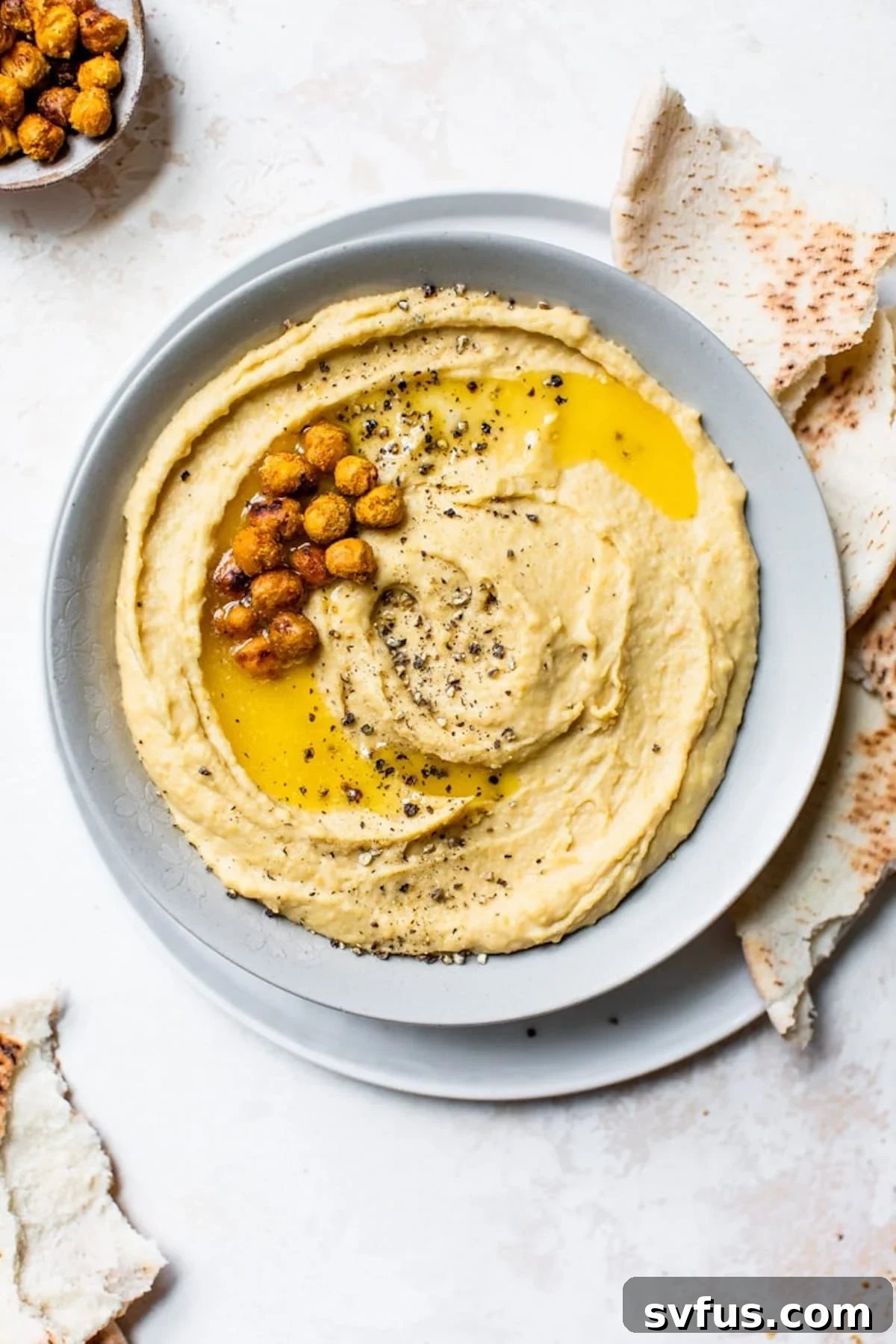 bowl of hummus with pita bread