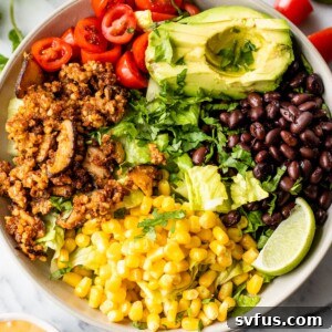 a bowl filled with corn, black beans, tomatoes, avocado, and walnut taco meat