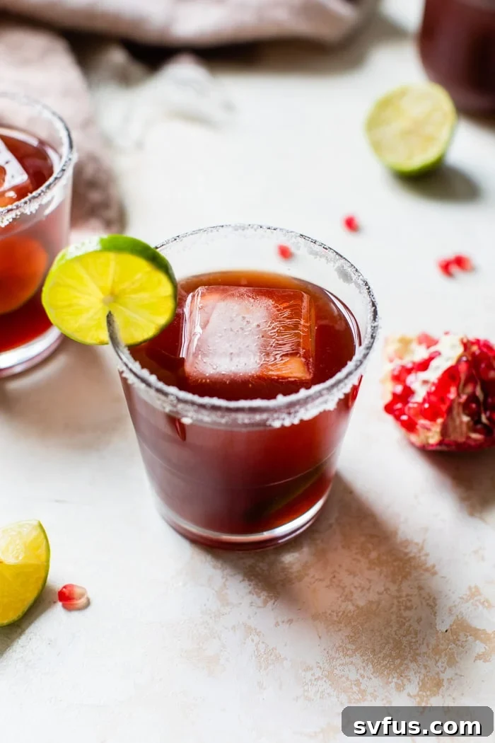 Pomegranate Margarita with lime and pomegranate aril garnish