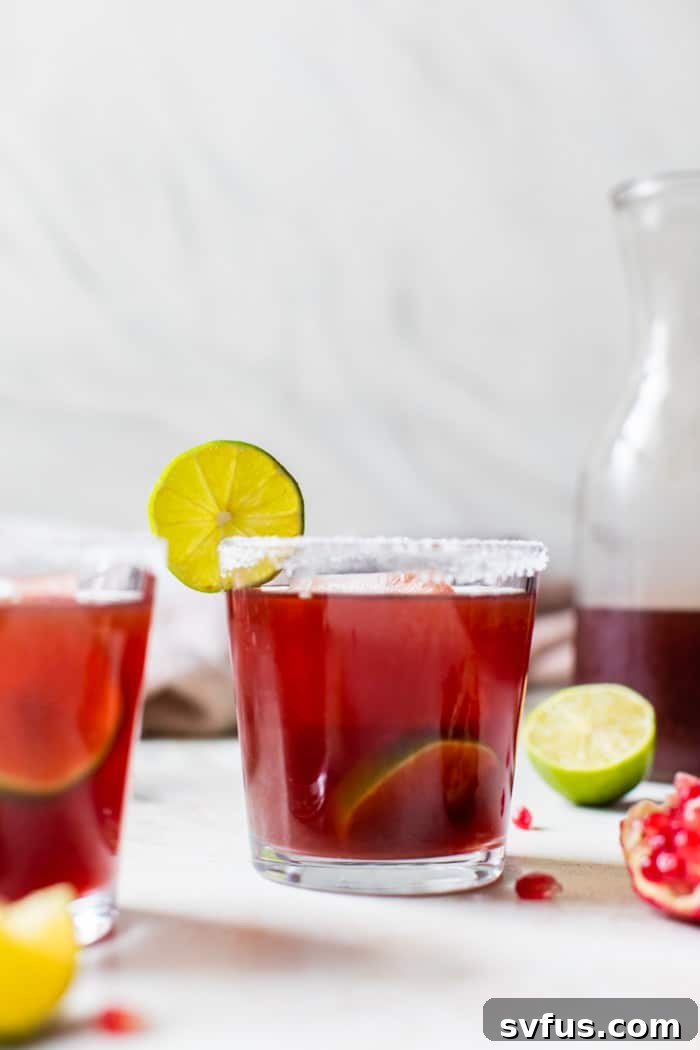 Pomegranate Margarita garnished with lime and pomegranate arils