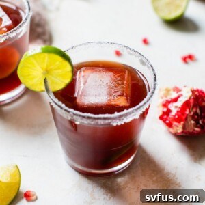 Pomegranate Margarita with lime garnish