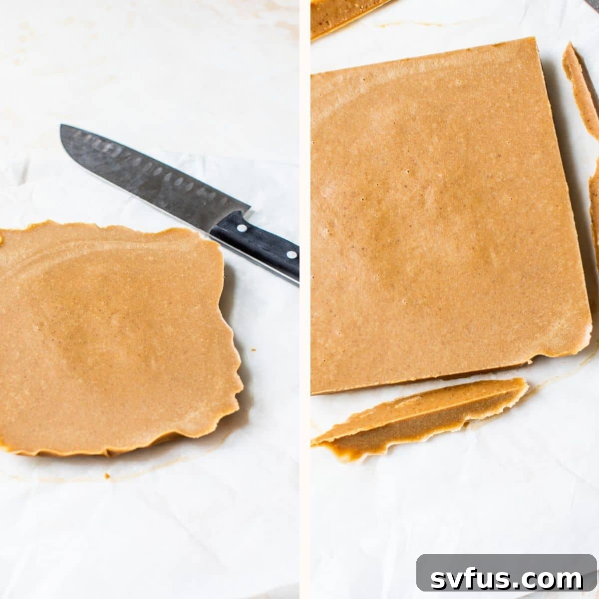 A large block of dairy-free peanut butter fudge cooling and setting in a parchment-lined baking dish, pulled from the freezer.