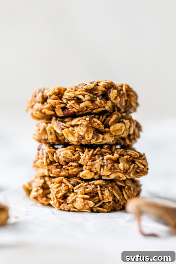 A perfectly stacked pile of No Bake Breakfast Cookies, highlighting their wholesome texture and inviting appearance. These healthy, quick-prep cookies are made with banana, oats, and almond butter, offering a delicious and easy breakfast or snack.