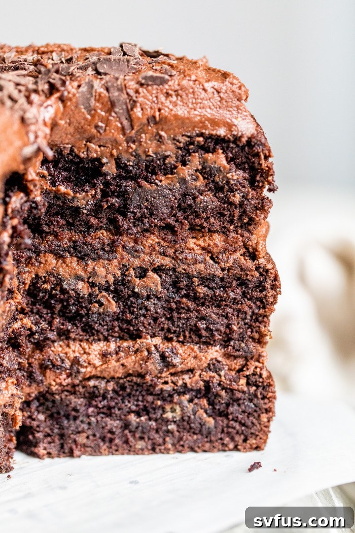 Close-up view of the rich chocolate avocado icing spread on the cake.